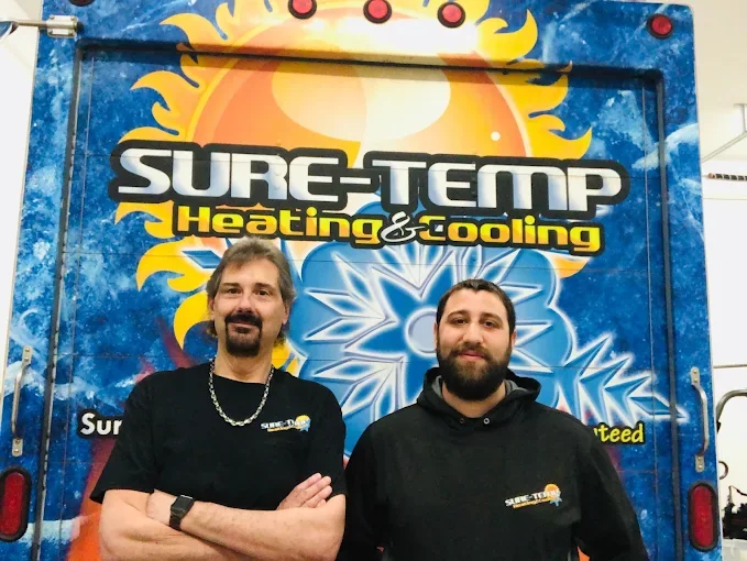 The Sure-Temp Heating & Cooling team in front of their service truck in Niagara Falls