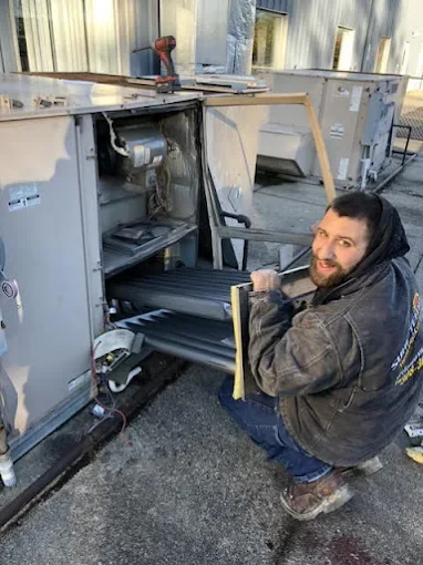 Sure-Temp technician repairing a commercial rooftop unit